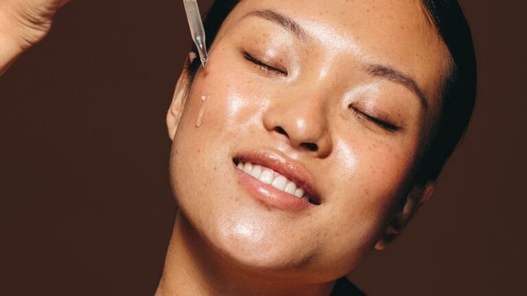 applying retinol serum to skin at night to treat hyperpigmentation and dark spots